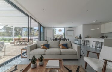 Living room in modern villa with and deck outside